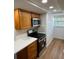 Updated kitchen featuring stainless steel appliances, quartz countertops and neutral cabinets at 118 S Halifax Ave # 409, Daytona Beach, FL 32118