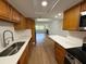 Modern kitchen with stainless steel appliances, neutral-toned cabinets, and breakfast bar seating at 118 S Halifax Ave # 409, Daytona Beach, FL 32118