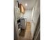 Bright laundry room features modern washer, dryer and overhead storage at 118 S Halifax Ave # 409, Daytona Beach, FL 32118
