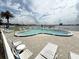 Beautiful waterfront pool area with comfortable lounge seating perfect for relaxing and enjoying the scenic view at 118 S Halifax Ave # 409, Daytona Beach, FL 32118