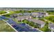 Aerial view of a vibrant community with multiple townhome buildings and ample parking at 130 Claire Ln, Davenport, FL 33837