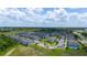 An aerial shot shows the community, with its apartments, green space, and parking spots under a cloudy sky at 130 Claire Ln, Davenport, FL 33837