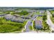 Aerial view of a residential community featuring townhomes, green spaces, and parking areas at 130 Claire Ln, Davenport, FL 33837