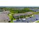 Aerial view of an apartment complex with ample parking, green spaces, and lush surrounding landscape at 130 Claire Ln, Davenport, FL 33837