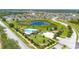 Aerial view of community pool, playground, and pond in a well-maintained neighborhood at 130 Claire Ln, Davenport, FL 33837