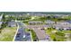An aerial view shows the apartments and neighborhood in the distance surrounding a retention pond at 130 Claire Ln, Davenport, FL 33837