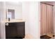 Bright bathroom featuring a vanity with dark cabinets and a shower with a patterned curtain at 130 Claire Ln, Davenport, FL 33837