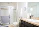 Bright bathroom featuring a walk-in shower with glass door and dark vanity at 130 Claire Ln, Davenport, FL 33837