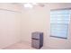 Neat bedroom featuring a compact refrigerator and a window with layered blinds at 130 Claire Ln, Davenport, FL 33837