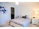 Cozy bedroom featuring a comfortable bed and stylish nightstand, creating a relaxing ambiance at 130 Claire Ln, Davenport, FL 33837