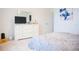 Neutral bedroom with white dresser, TV, and soft carpet at 130 Claire Ln, Davenport, FL 33837