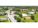 Welcoming community entrance with stone pillars, manicured landscaping, and a glimpse of the pool at 130 Claire Ln, Davenport, FL 33837