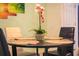 Dining room showcasing a round table set for four, featuring floral arrangements at 130 Claire Ln, Davenport, FL 33837