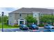 Stylish townhomes boast neutral siding, manicured lawns, and convenient parking spaces at 130 Claire Ln, Davenport, FL 33837
