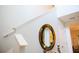 Foyer displaying a mirror and decorative table situated near a staircase with white railing at 130 Claire Ln, Davenport, FL 33837