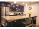 Modern kitchen with stainless steel appliances, granite countertops, and breakfast bar seating at 130 Claire Ln, Davenport, FL 33837
