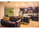 A living room and kitchen featuring an eat-in breakfast bar and stainless steel appliances at 130 Claire Ln, Davenport, FL 33837