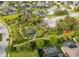 A high-angle view of a community park featuring a basketball court and playground area surrounded by lush greenery at 1415 Ellis Fallon Loop, Oviedo, FL 32765