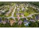 Aerial view of the home surrounded by a neighborhood of houses and lush trees at 1415 Ellis Fallon Loop, Oviedo, FL 32765