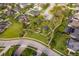 An aerial view of a green residential area highlighting a community park, and homes with manicured lawns at 1415 Ellis Fallon Loop, Oviedo, FL 32765