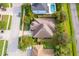 Aerial view of the home with surrounding trees, landscaping, and a driveway at 1415 Ellis Fallon Loop, Oviedo, FL 32765