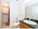 Bathroom with a granite-look vanity top, a white sink, toilet, and shower at 1415 Ellis Fallon Loop, Oviedo, FL 32765