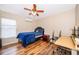 Bedroom featuring wood-look floors, a ceiling fan, and a bed with blue bedding at 1415 Ellis Fallon Loop, Oviedo, FL 32765