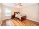 Bedroom features wood-look floors, a ceiling fan, and a wooden bed frame at 1415 Ellis Fallon Loop, Oviedo, FL 32765