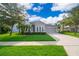 Charming single-Gathering home with well-manicured lawn, mature trees, and a two-car garage at 1415 Ellis Fallon Loop, Oviedo, FL 32765