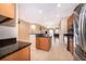 Bright, open kitchen with stainless steel appliances and a seamless view into the living area at 1415 Ellis Fallon Loop, Oviedo, FL 32765