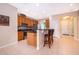 Well-lit kitchen features stainless steel appliances, breakfast bar with stools, and granite countertops at 1415 Ellis Fallon Loop, Oviedo, FL 32765