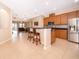 Open kitchen with stainless steel appliances, breakfast bar, and ample counter space at 1415 Ellis Fallon Loop, Oviedo, FL 32765