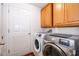 Well-equipped laundry room with washer, dryer, cabinets, and access to exterior at 1415 Ellis Fallon Loop, Oviedo, FL 32765