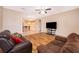 Spacious living room featuring wood floors, ceiling fan, and ample natural light at 1415 Ellis Fallon Loop, Oviedo, FL 32765