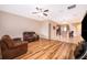 Open-concept living room with wood floors flowing into kitchen, perfect for entertaining at 1415 Ellis Fallon Loop, Oviedo, FL 32765
