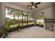 Large screened patio with a ceiling fan and an outdoor kitchen area at 1415 Ellis Fallon Loop, Oviedo, FL 32765