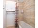 Shower with tiled walls, shower curtain, and white storage cabinet at 1415 Ellis Fallon Loop, Oviedo, FL 32765