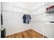 Spacious walk-in closet with wood floors and ample shelving for organized storage at 1415 Ellis Fallon Loop, Oviedo, FL 32765