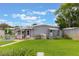 Well-maintained backyard with lush green grass, patio area, and storage shed, ideal for outdoor activities at 142 Florence Blvd, Debary, FL 32713