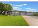 Charming single-story home with a well-manicured lawn and brick driveway at 142 Florence Blvd, Debary, FL 32713