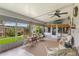 Inviting lanai features wicker furniture, ceiling fan, and screened windows offering a serene outdoor living space at 142 Florence Blvd, Debary, FL 32713