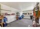 Spacious storage area for tools, equipment, and household items with white walls, shelves, and gray carpet at 142 Florence Blvd, Debary, FL 32713