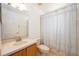 This bathroom features a single sink vanity, a toilet, and a shower/tub combo with neutral tile and a shower curtain at 14224 Colonial Lakes Dr, Orlando, FL 32826