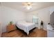 Cozy bedroom featuring hardwood floors, a double bed, a window, and ample closet space at 14224 Colonial Lakes Dr, Orlando, FL 32826