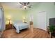 Serene bedroom with wood flooring, a ceiling fan, and an ensuite bathroom, offering comfort and privacy at 14224 Colonial Lakes Dr, Orlando, FL 32826