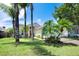 Charming single-Gathering home with a lush green lawn, mature trees, and a well-manicured landscape at 14224 Colonial Lakes Dr, Orlando, FL 32826