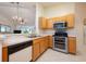 Functional kitchen featuring stainless steel appliances, light wood cabinets, and a convenient breakfast bar area at 14224 Colonial Lakes Dr, Orlando, FL 32826