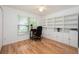 Bright office space with hardwood floors, large window, and custom built-in shelving with storage at 14224 Colonial Lakes Dr, Orlando, FL 32826