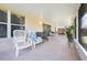 Covered patio featuring outdoor seating, tile flooring, and windows providing natural light at 14224 Colonial Lakes Dr, Orlando, FL 32826