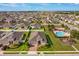 Aerial view of a home with a community pool and playground at 147 Seville Dr, Davenport, FL 33837